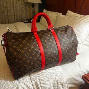 Louis Vuitton Monogram 45”Duffel Bag with Red Trim and Handles.